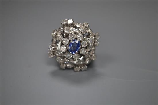 A white metal, sapphire and diamond set large cluster ring, size M, gross 8.9 grams.